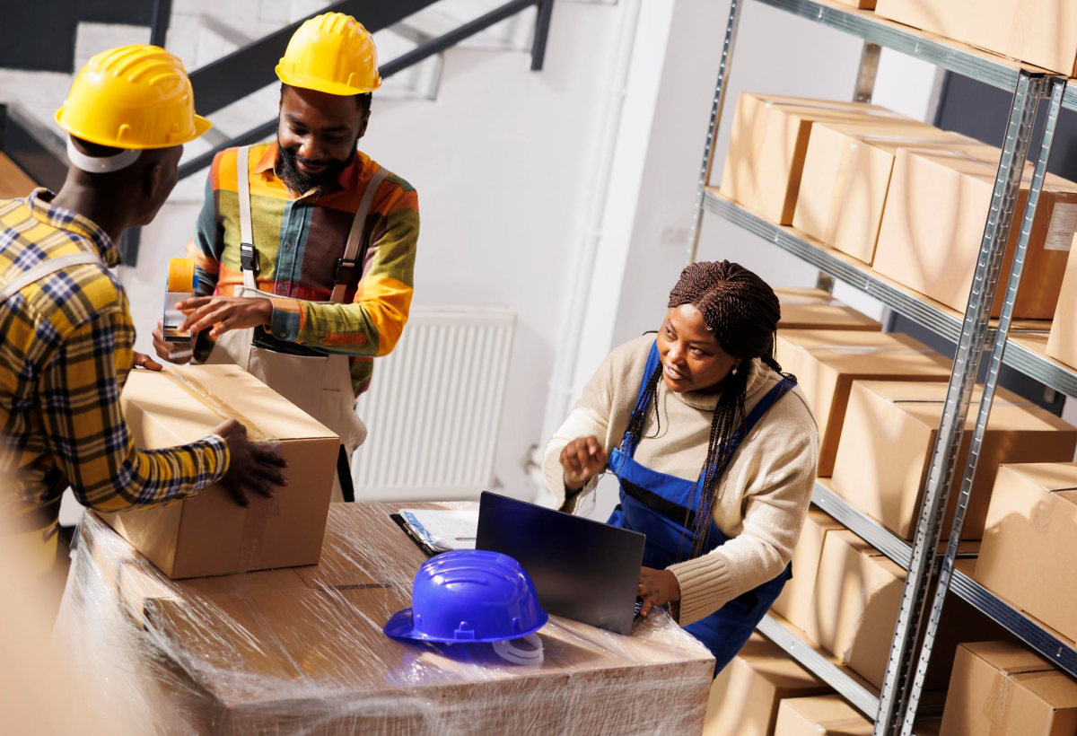warehouse-manager-checking-orders-list-coordinating-parcels-packing-process-african-american-woman-supervisor-with-laptop-controlling-freight-cardboard-boxes-sealing-dispatching