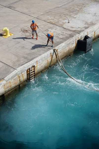 Two_workers_pulling_rope_out_of_water